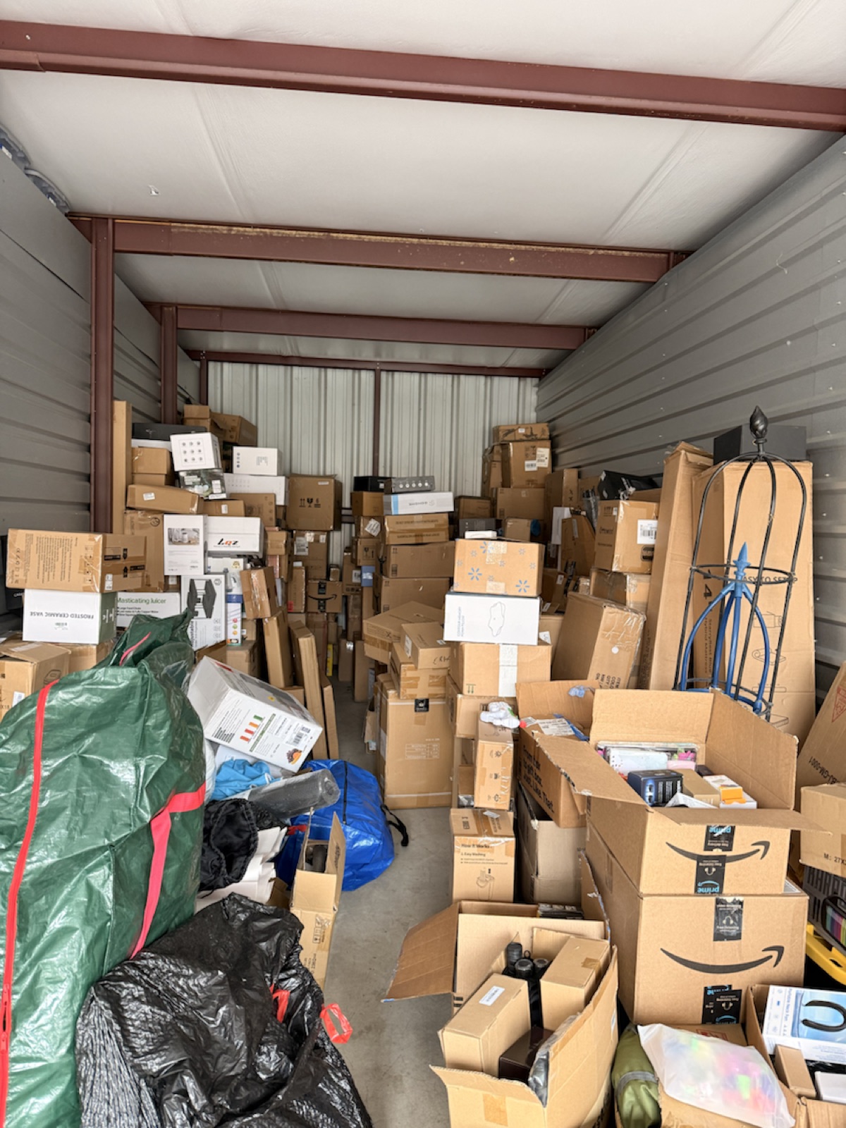 Deep storage unit photo showing long rows of Amazon boxes and wholesale merchandise